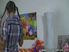 Pigtail teen playing explicitly with dolls