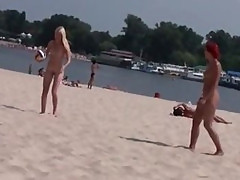Two skinny nudist teens frolic around the beach